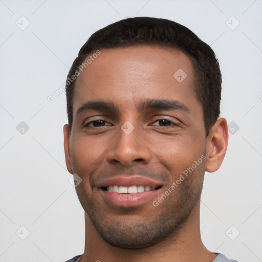 Joyful white young-adult male with short  black hair and brown eyes