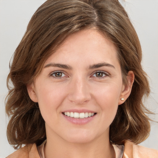 Joyful white young-adult female with long  brown hair and grey eyes