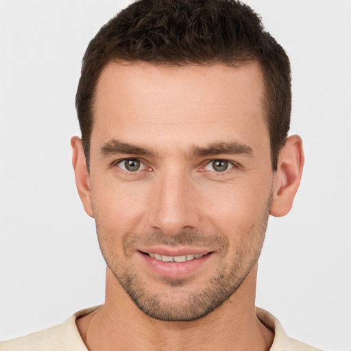 Joyful white young-adult male with short  brown hair and brown eyes