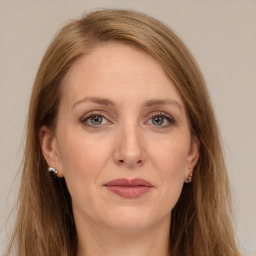 Joyful white adult female with long  brown hair and grey eyes