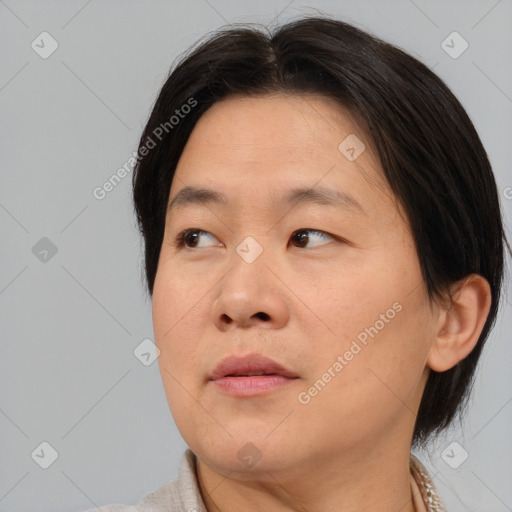 Neutral asian adult female with medium  brown hair and brown eyes