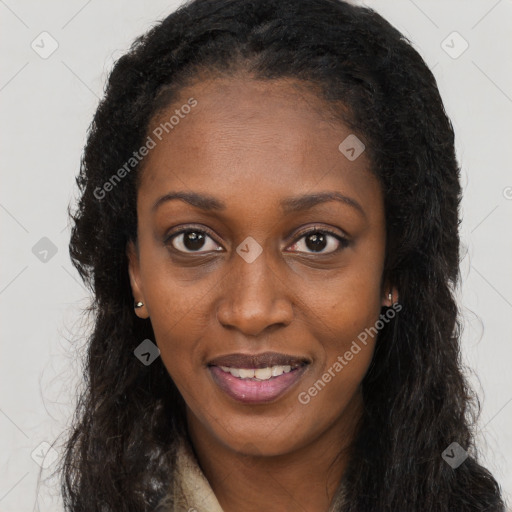 Joyful black young-adult female with long  brown hair and brown eyes