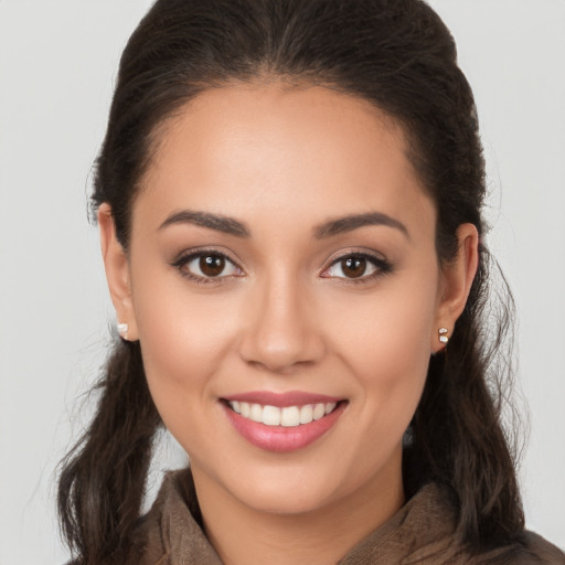 Joyful white young-adult female with long  brown hair and brown eyes