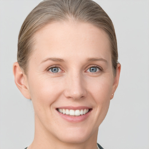 Joyful white young-adult female with short  brown hair and grey eyes