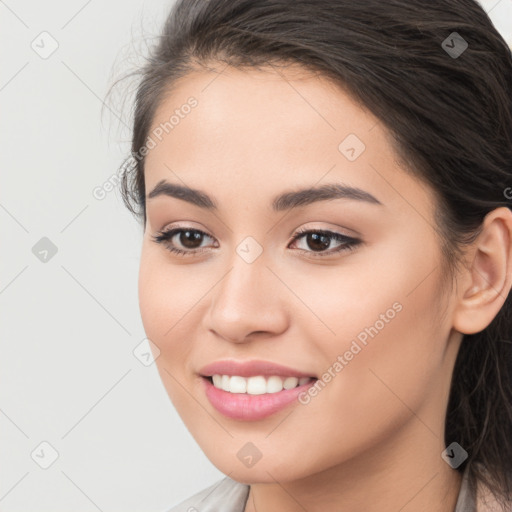 Joyful white young-adult female with long  brown hair and brown eyes