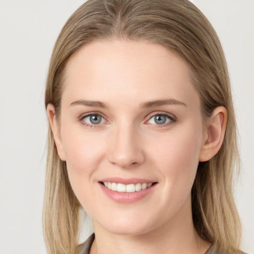 Joyful white young-adult female with long  brown hair and grey eyes