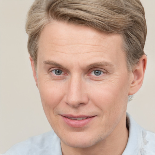 Joyful white adult male with short  brown hair and grey eyes