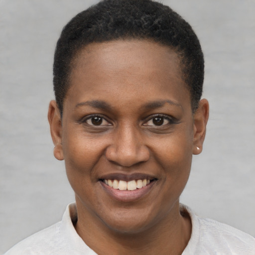 Joyful black young-adult female with short  brown hair and brown eyes