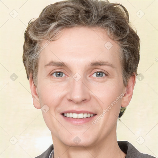 Joyful white adult male with short  brown hair and grey eyes