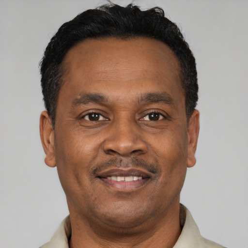 Joyful latino adult male with short  black hair and brown eyes