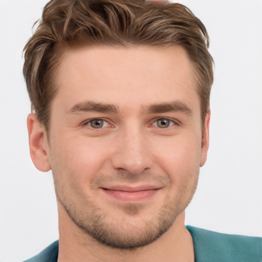 Joyful white young-adult male with short  brown hair and grey eyes