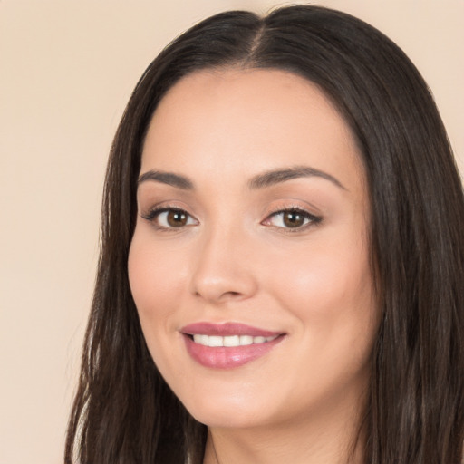 Joyful white young-adult female with long  black hair and brown eyes