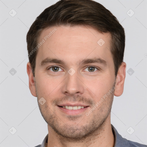 Joyful white young-adult male with short  brown hair and grey eyes