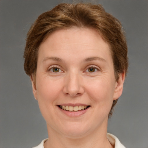 Joyful white adult female with short  brown hair and grey eyes