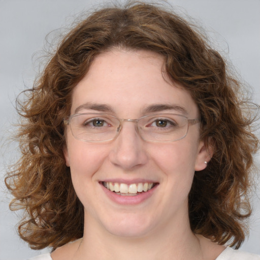 Joyful white adult female with medium  brown hair and green eyes