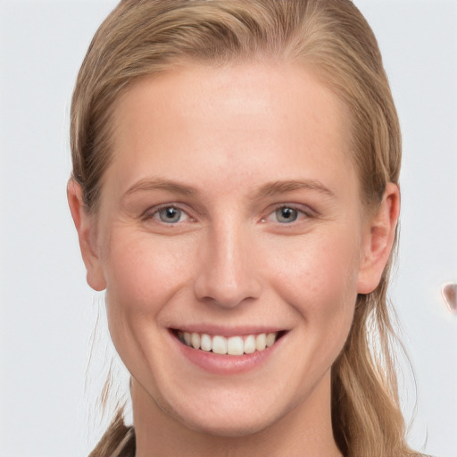 Joyful white young-adult female with long  brown hair and grey eyes