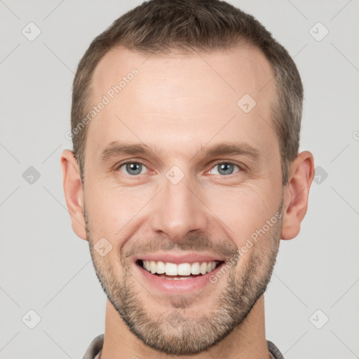 Joyful white young-adult male with short  brown hair and grey eyes