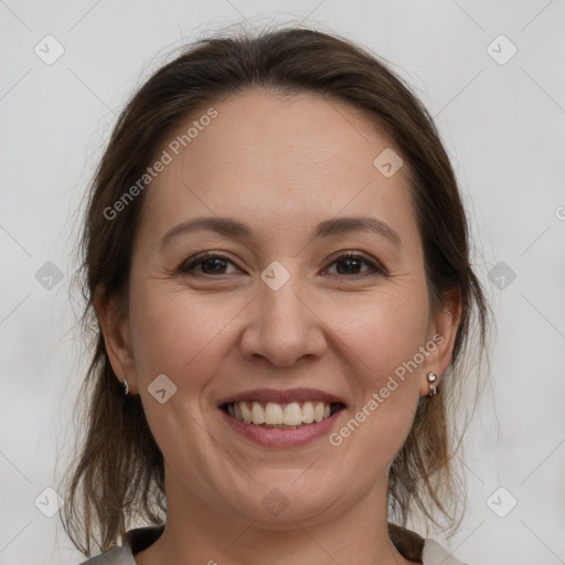 Joyful white adult female with medium  brown hair and brown eyes