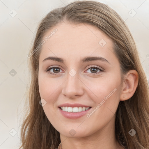 Joyful white young-adult female with long  brown hair and blue eyes