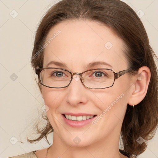 Joyful white adult female with medium  brown hair and blue eyes