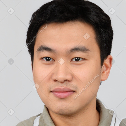 Joyful asian young-adult male with short  black hair and brown eyes