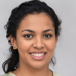 Joyful latino young-adult female with medium  brown hair and brown eyes