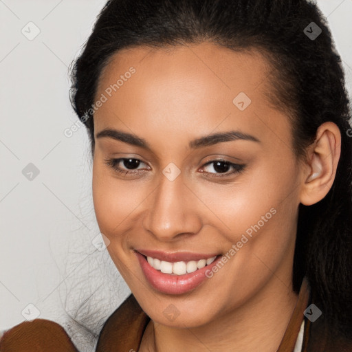 Joyful latino young-adult female with long  brown hair and brown eyes