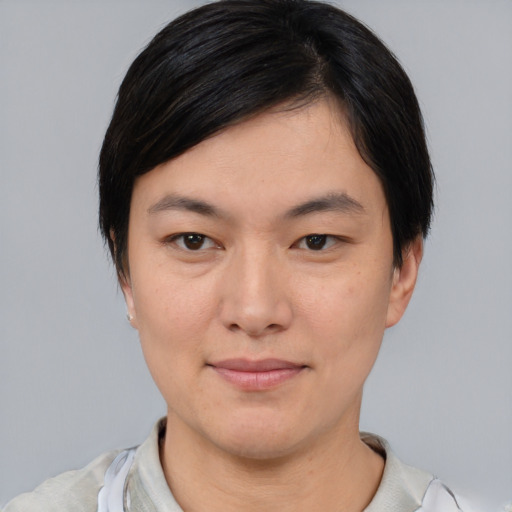 Joyful asian young-adult female with short  brown hair and brown eyes