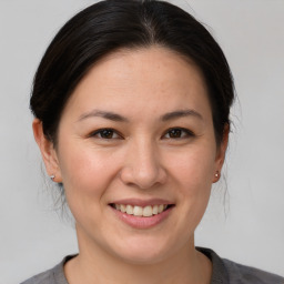 Joyful white young-adult female with medium  brown hair and brown eyes