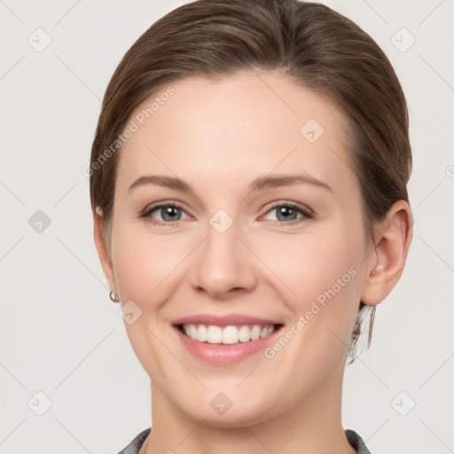 Joyful white young-adult female with short  brown hair and grey eyes