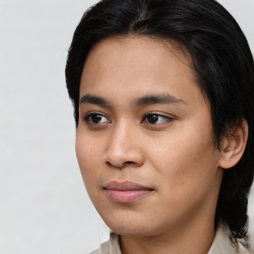 Joyful asian young-adult male with medium  black hair and brown eyes