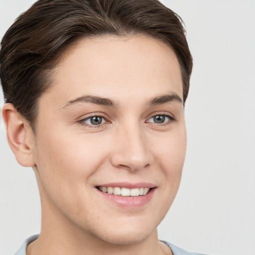 Joyful white young-adult female with short  brown hair and grey eyes