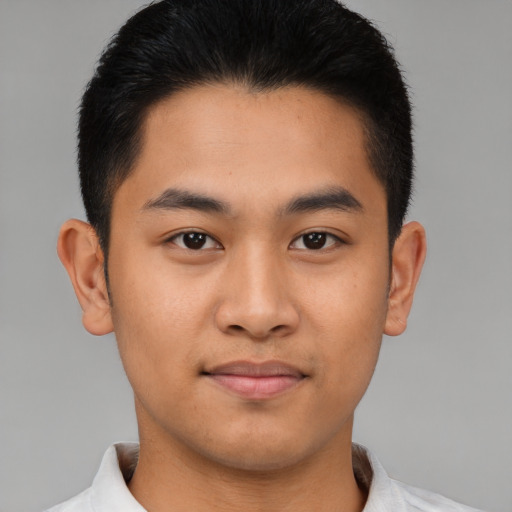 Joyful asian young-adult male with short  brown hair and brown eyes