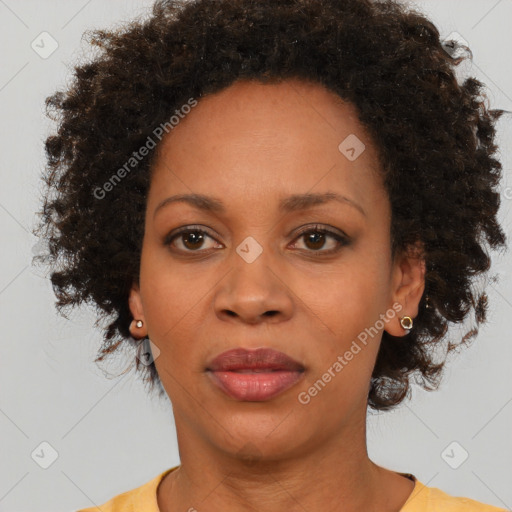 Joyful black adult female with short  brown hair and brown eyes