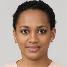 Joyful black young-adult female with short  brown hair and brown eyes