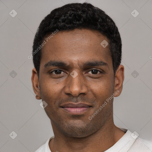 Joyful black young-adult male with short  black hair and brown eyes