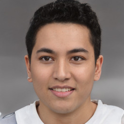 Joyful latino young-adult male with short  brown hair and brown eyes