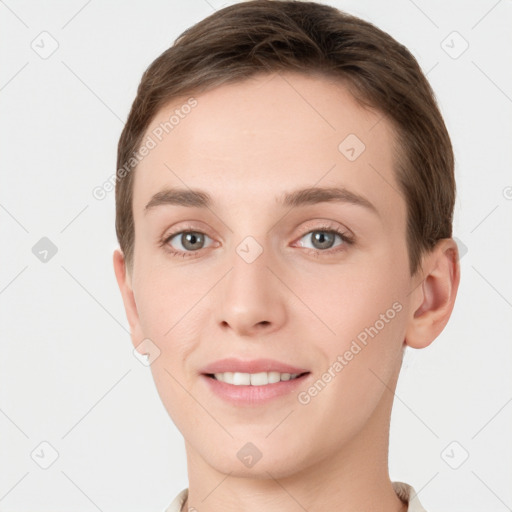 Joyful white young-adult female with short  brown hair and grey eyes