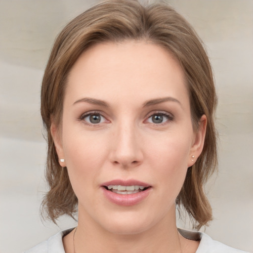 Joyful white young-adult female with medium  brown hair and grey eyes