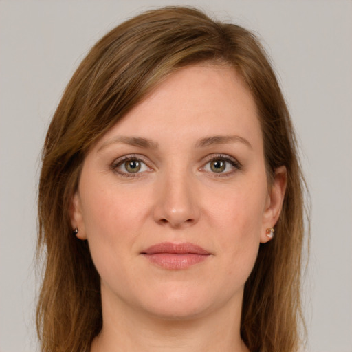 Joyful white young-adult female with long  brown hair and grey eyes