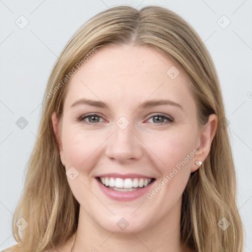 Joyful white young-adult female with long  brown hair and blue eyes