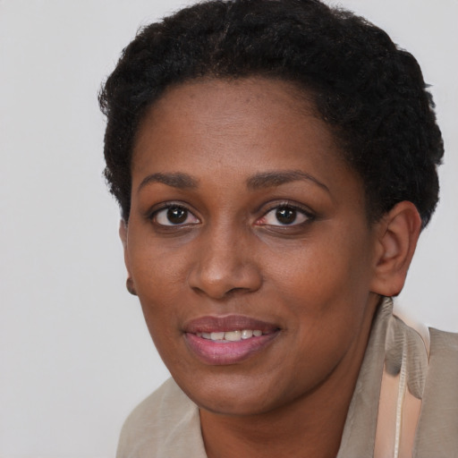 Joyful black young-adult female with short  brown hair and brown eyes