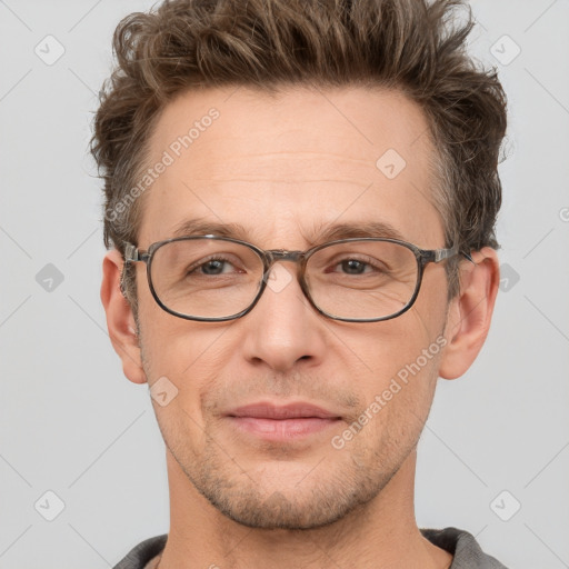 Joyful white adult male with short  brown hair and grey eyes