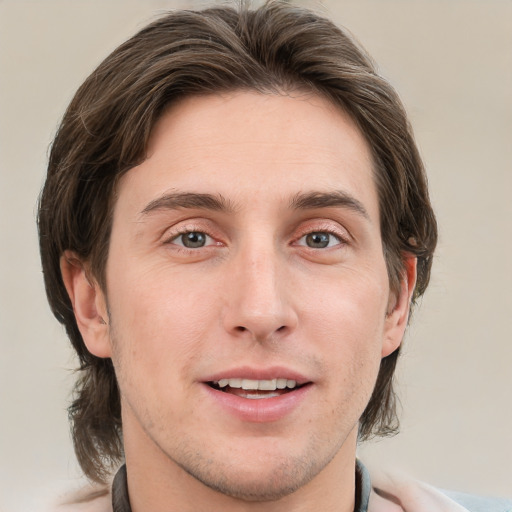 Joyful white adult male with short  brown hair and grey eyes