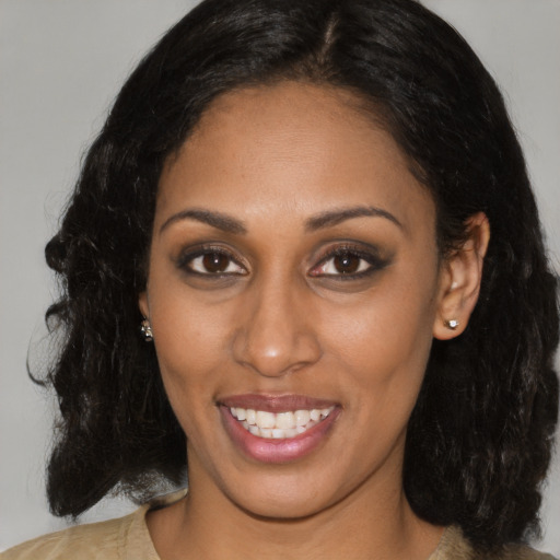 Joyful black adult female with medium  black hair and brown eyes