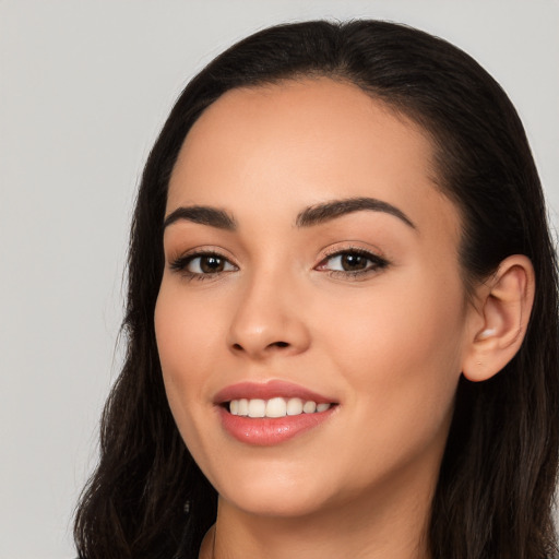 Joyful white young-adult female with long  black hair and brown eyes