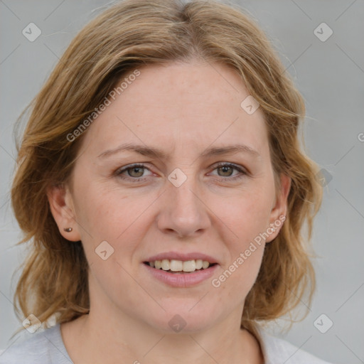 Joyful white adult female with medium  brown hair and blue eyes