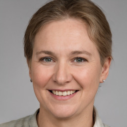 Joyful white adult female with medium  brown hair and grey eyes