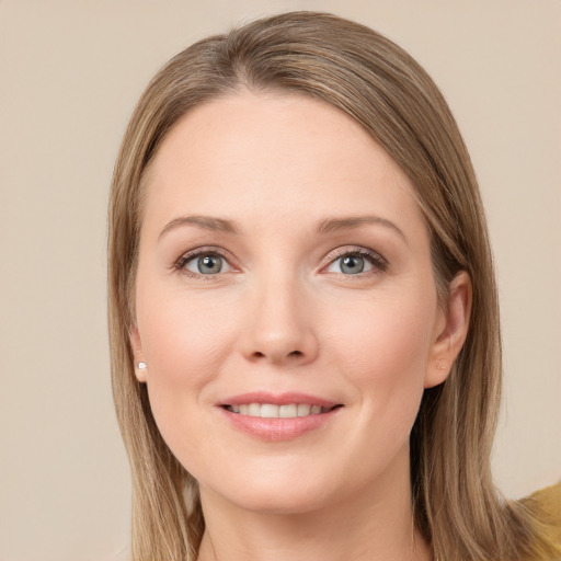 Joyful white young-adult female with long  brown hair and grey eyes