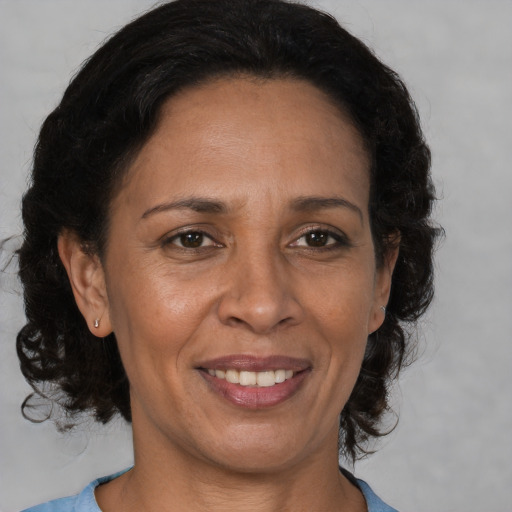 Joyful black adult female with medium  brown hair and brown eyes